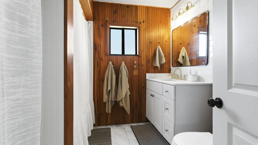 Wood-paneled wall accenting a single window