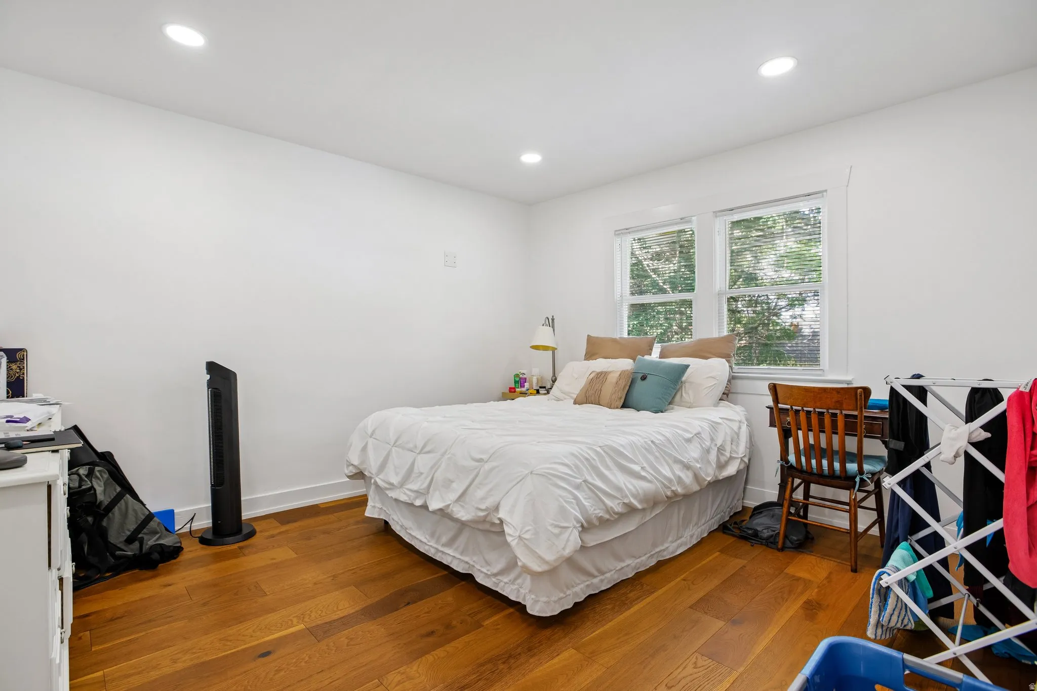 Recessed lighting, wood-finish flooring, white walls, and white trim