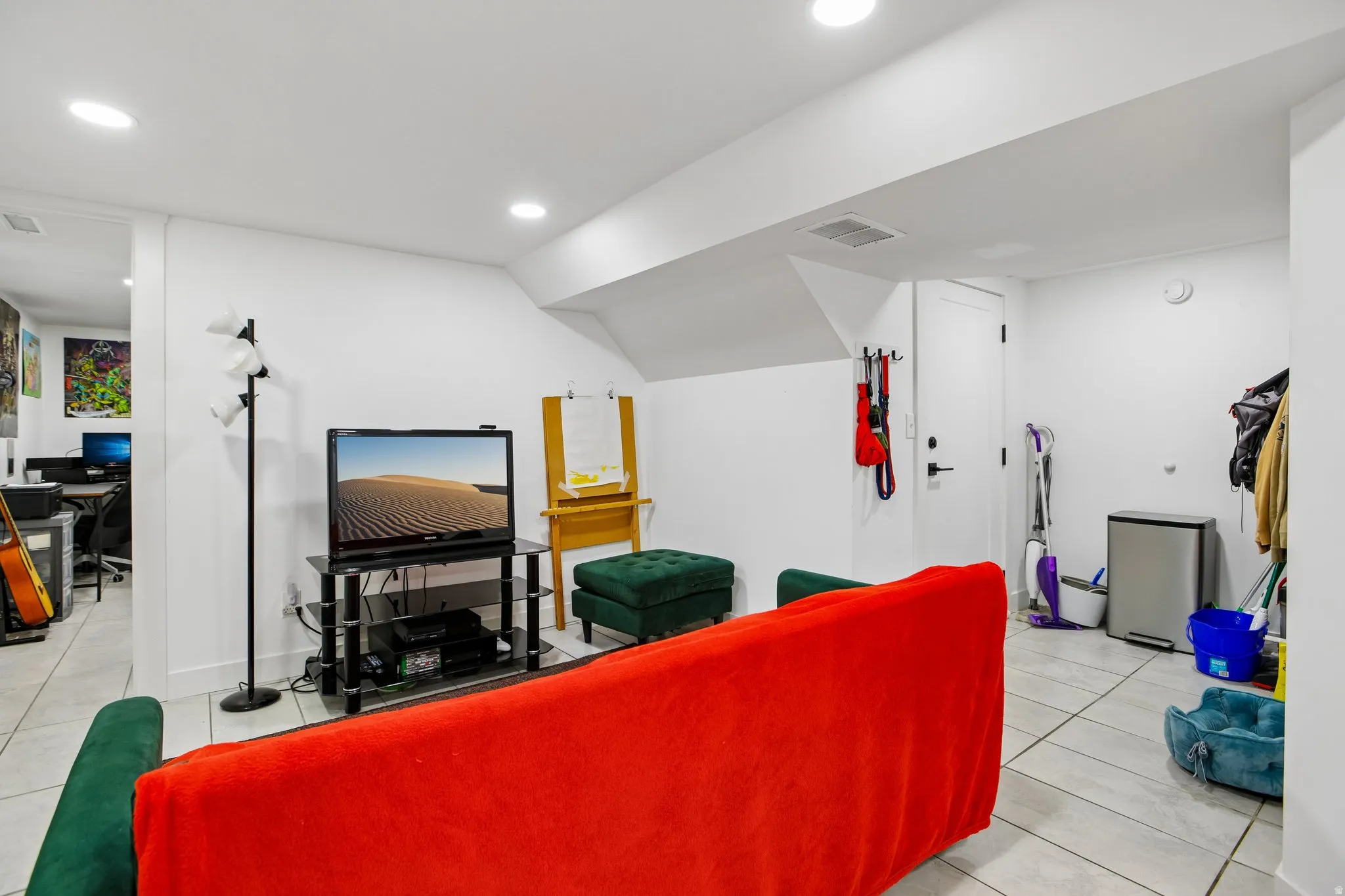 Recessed lighting illuminates the space with a tiled floor