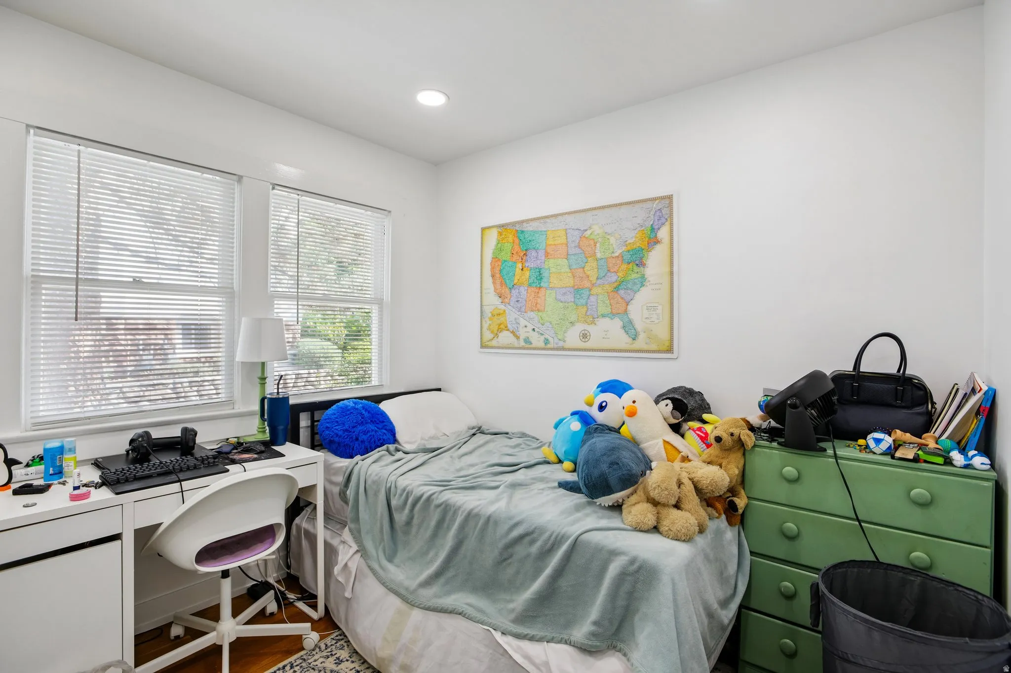 Recessed lighting, wood-finish flooring, and white walls