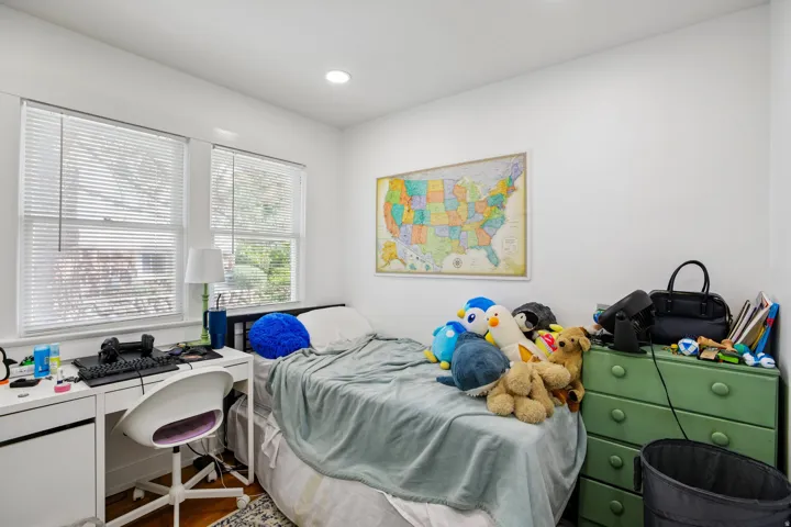 Recessed lighting, wood-finish flooring, and white walls