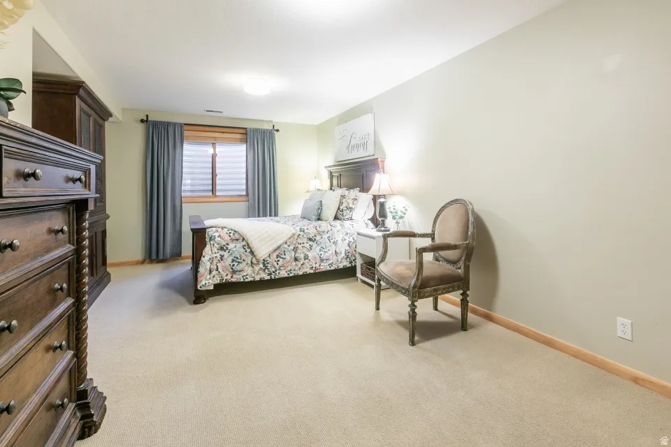 Soft neutral wall color, plush carpet flooring, recessed window, and light wood trim