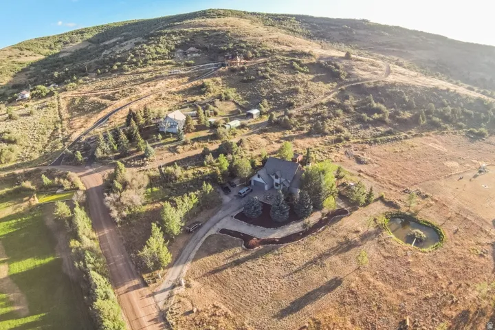 Expansive property featuring a residence, detached building, and a private pond