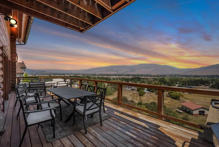 Expansive wood deck with a durable railing system and an exposed wood ceiling