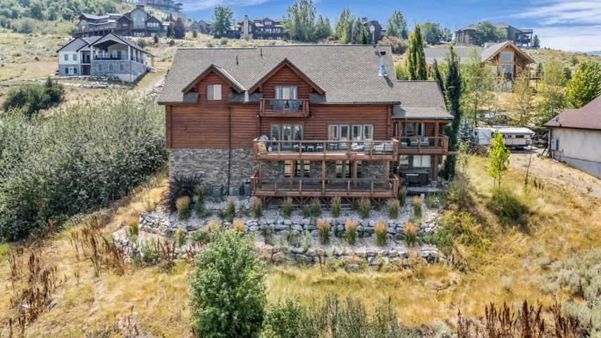 Stunning wood-finish exterior with dual gabled rooflines and stone foundation accents