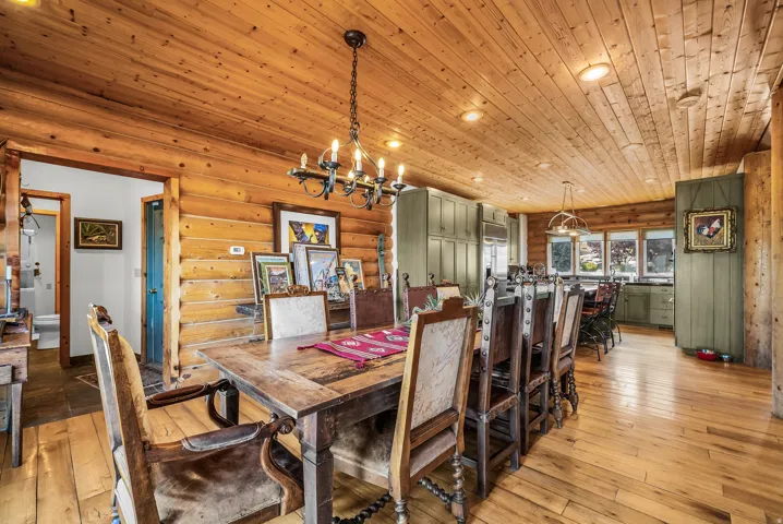 Expansive wood-finish flooring, wood-paneled walls, wood-paneled ceilings, built-in cabinetry, and multi-pane windows