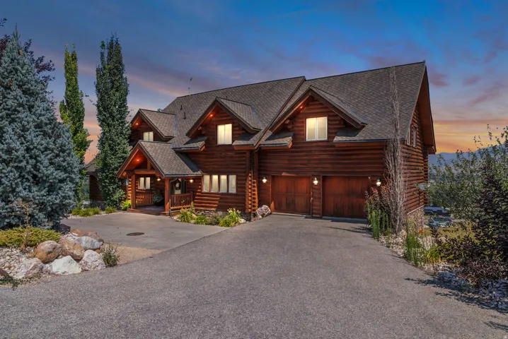 Log cabin exterior with multiple gables and a covered porch