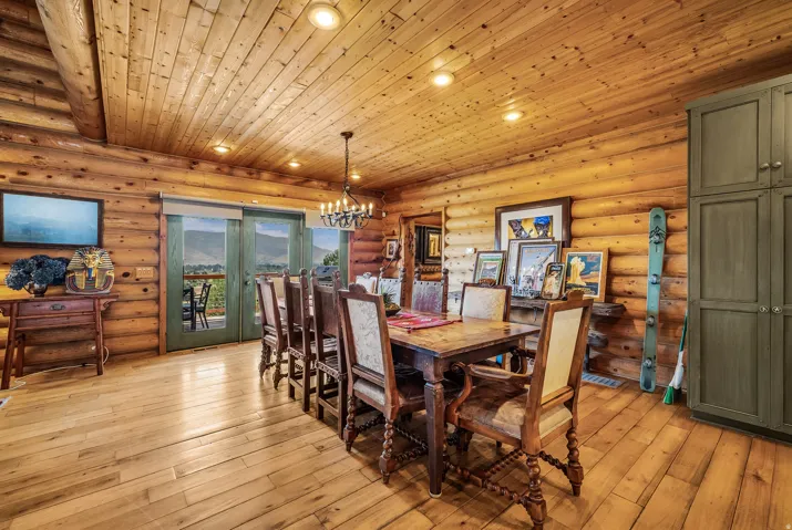 Log walls and wood-finish flooring with a wood plank ceiling