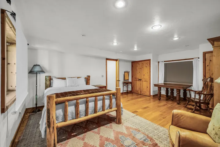Hardwood flooring, natural wood doors, recessed lighting, and a wide window opening