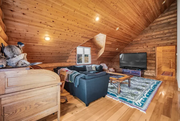Wood-paneled walls and ceiling with sloped architectural details