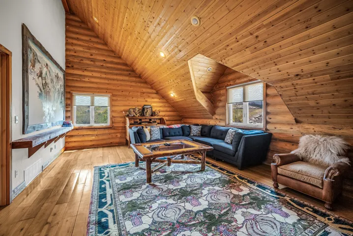 Wood-paneled sloped ceiling, wood-finish flooring, recessed lighting, and built-in shelving
