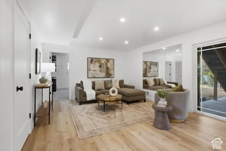 Recessed lighting, light wood-finish flooring, white walls, and a sliding glass door to the rear yard