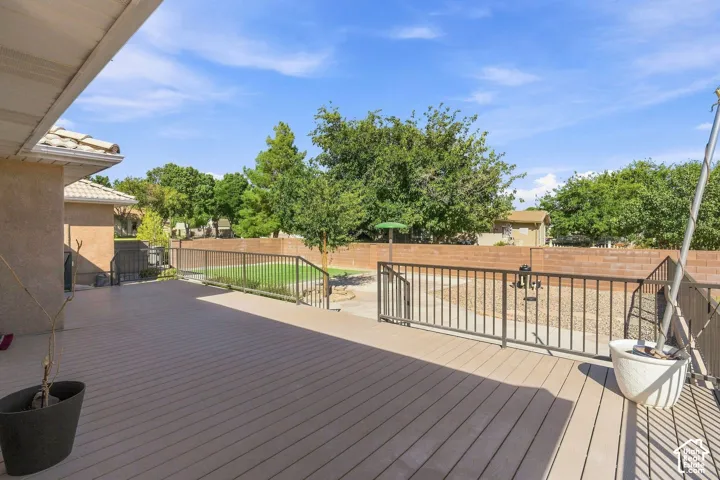 Expansive outdoor deck with composite wood-finish flooring, featuring a metal railing system