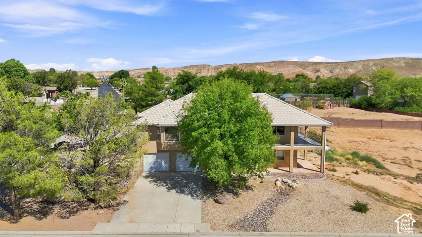 Two-story residence with a concrete driveway and an attached two-car garage
