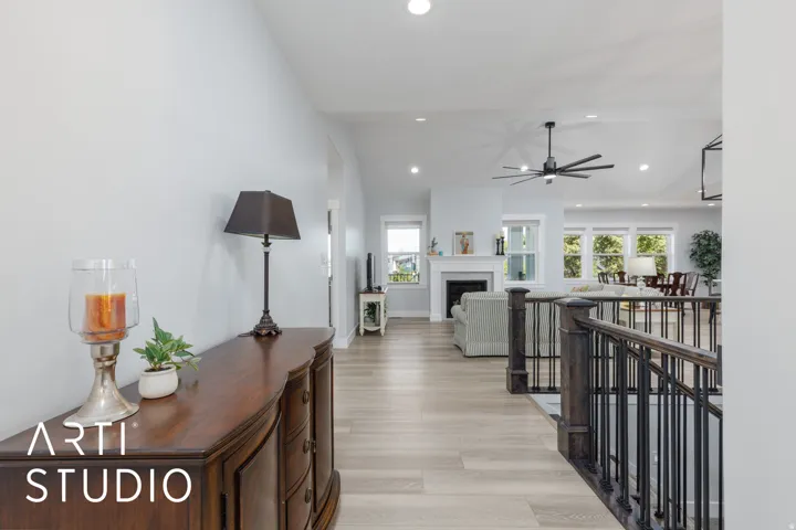 Wide plank wood-finish flooring, recessed lighting, and a modern ceiling fan