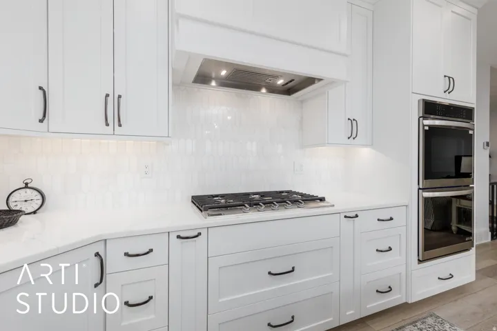 White shaker cabinetry with dark hardware