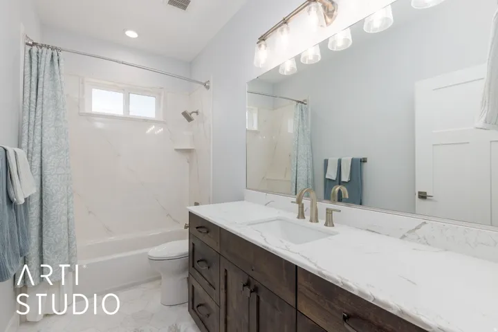 Full vanity with dual sinks, brushed nickel fixtures, and a large mirror