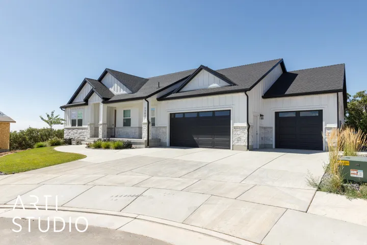 Contemporary exterior with white vertical siding and stone accents