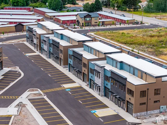 Modern multi-story buildings featuring varied facades of stone, siding, and paneling