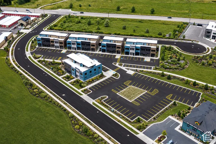 Contemporary architecture with multi-story buildings, extensive paved parking, and manicured landscaping