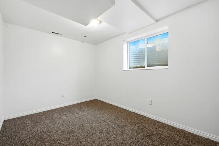 Neutral wall finish, recessed lighting, and carpeted flooring