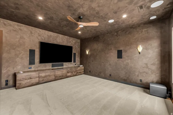 Textured wall finish, recessed ceiling lighting, ceiling fan, built-in media console, wall-mounted sconces