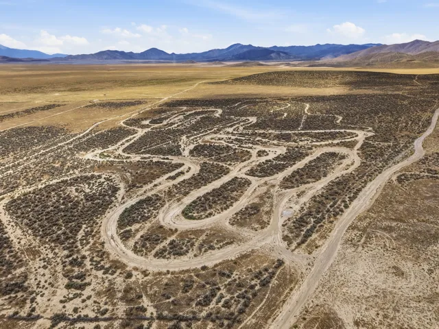 Expansive desert landscape featuring natural terrain and distant mountains