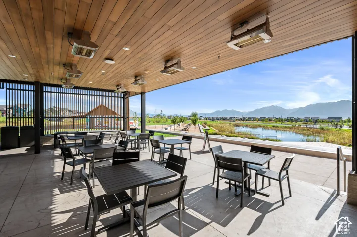Covered patio with a wood-finish ceiling, mounted heaters, and recessed lighting