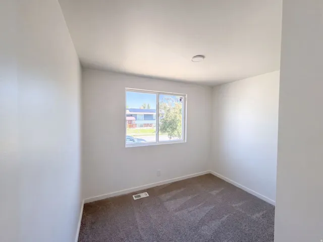Neutral wall paint, window with exterior exposure, recessed ceiling light, and carpet flooring