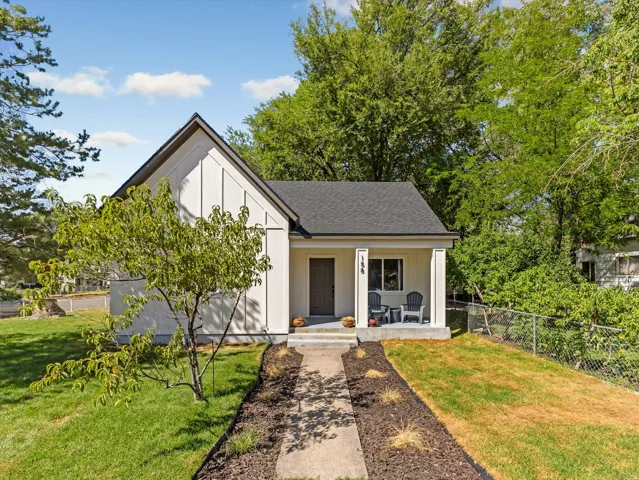 Contemporary exterior with gabled roofline and vertical white siding