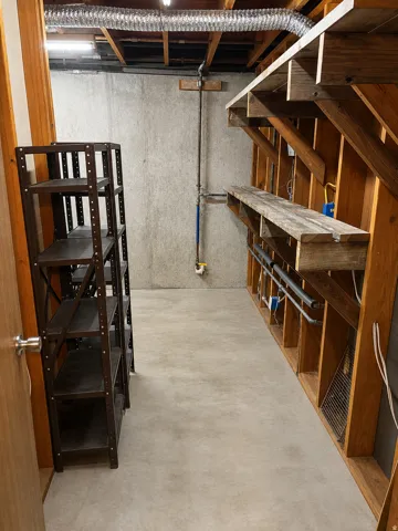 Concrete flooring in a versatile utility space with exposed ductwork