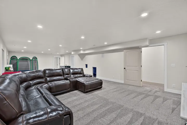 Recessed lighting, light-toned walls, and carpet flooring