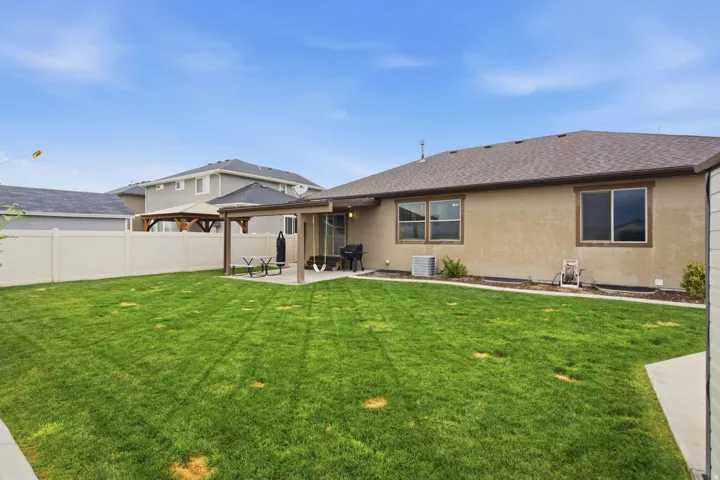 Expansive green lawn with a privacy fence