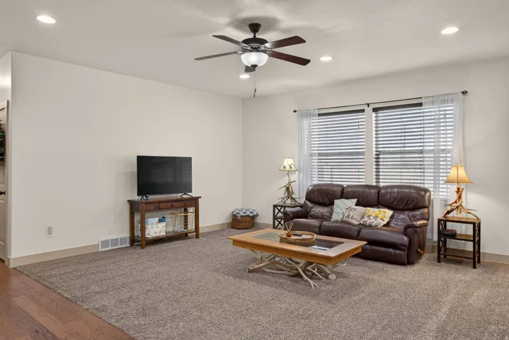 Recessed lighting, ceiling fan, carpet flooring, window blinds, and wood-finish flooring