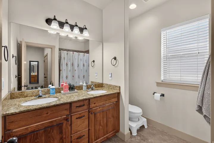 Dual vanity with undermount sinks and wood-finish cabinetry