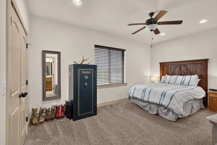 Recessed lighting, ceiling fan with light fixture, window with blinds, wood-finish door, and carpeted flooring