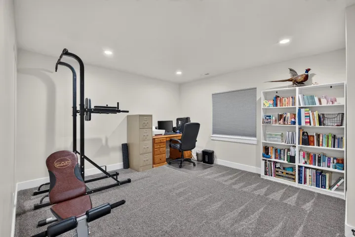 Neutral wall tones, recessed ceiling lighting, and gray patterned carpeting