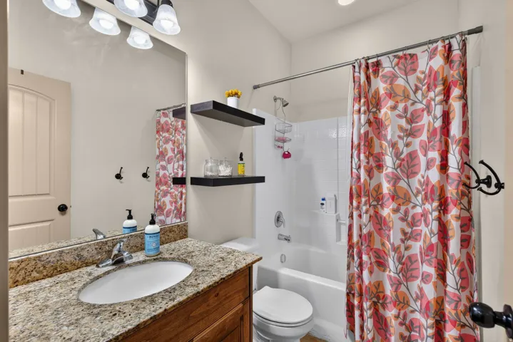 Vanity featuring a built-in sink and granite countertop