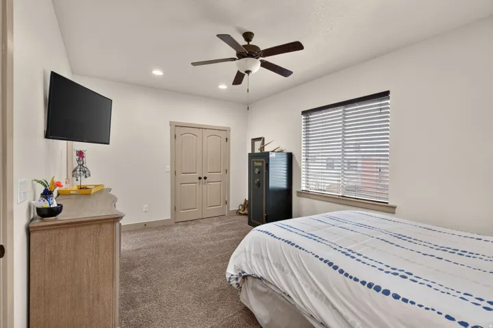 Recessed lighting, ceiling fan, carpeted flooring, window with blinds, and double-entry doors