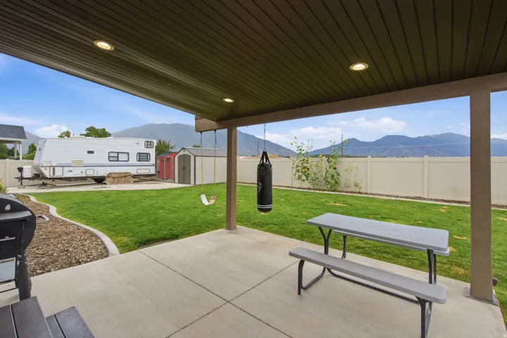 Expansive covered patio with recessed lighting, concrete flooring, and an open-air design