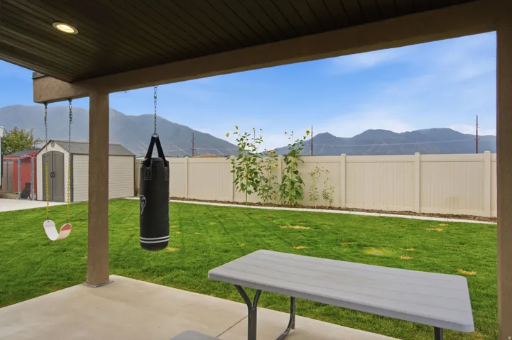 Covered patio with recessed lighting, concrete flooring, and an expansive lawn