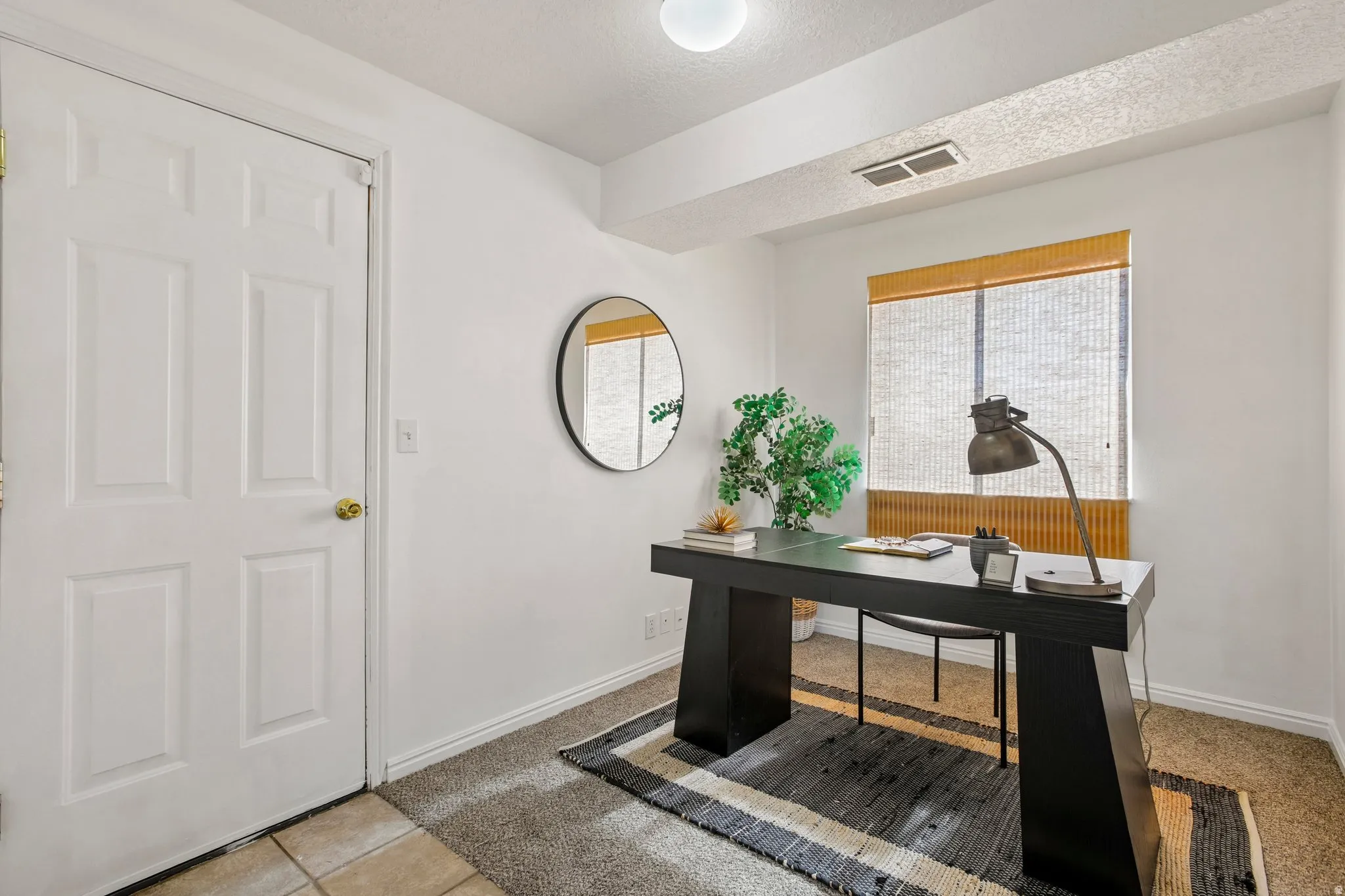 Recessed ceiling lighting, window with horizontal blinds, neutral wall paint, and carpet flooring