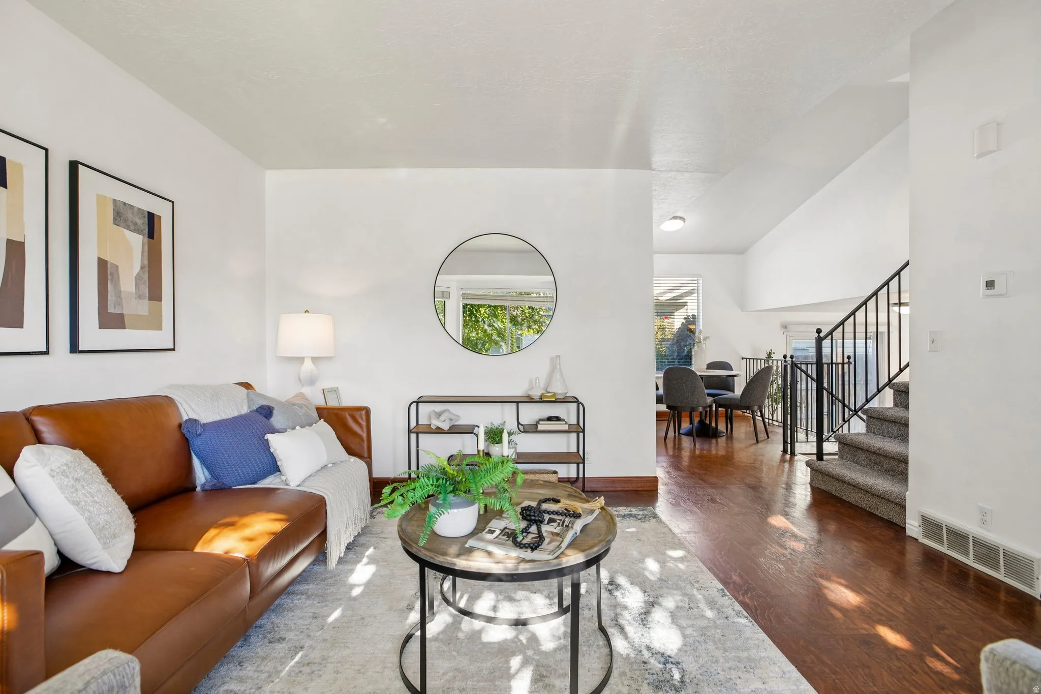 Bright living area featuring wood-finish flooring and white walls