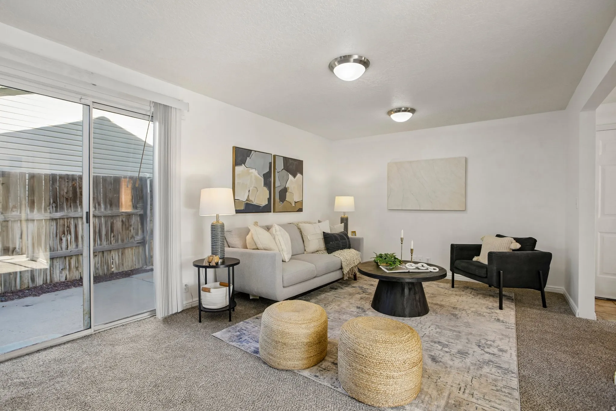 Sliding glass door to a fenced yard, recessed ceiling lighting, and a neutral color palette