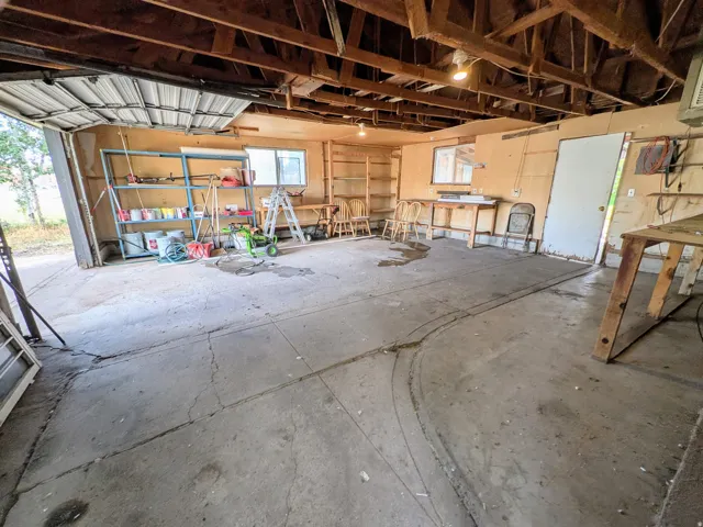 Concrete flooring, exposed ceiling joists, and a single-pane window