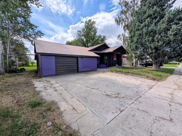 Attached garage with a metal roll-up door
