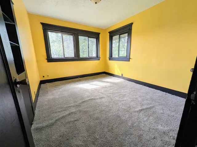 Built-in shelving, two windows, and dark trim details