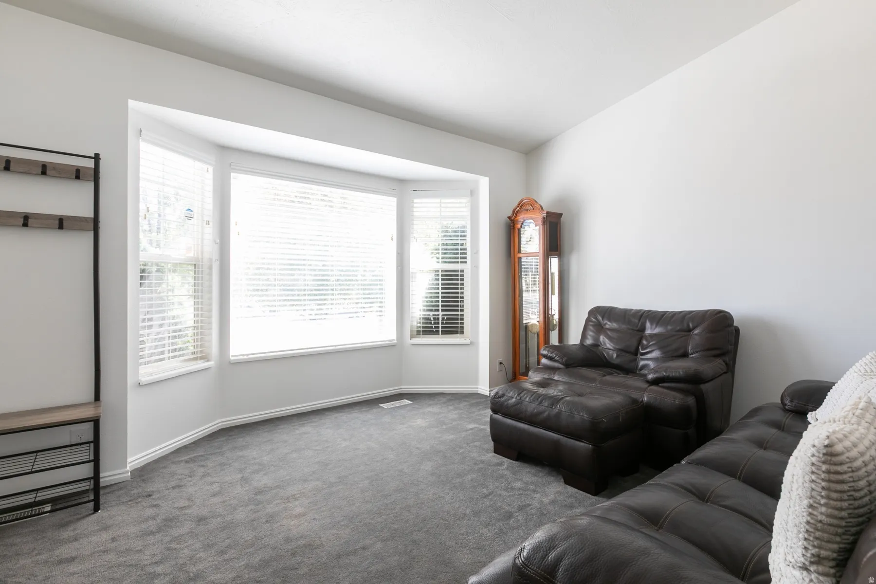 Bay window with multiple panels, white trim, and Venetian blinds