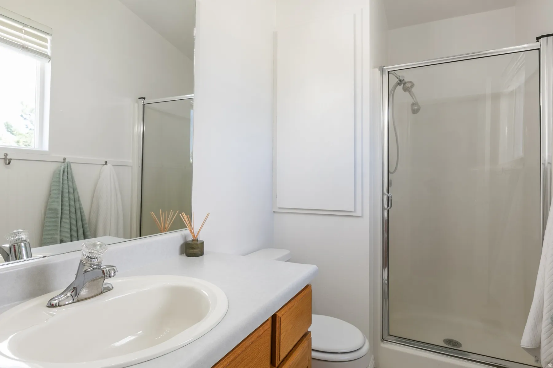 Bathroom with a vanity featuring a built-in sink, chrome faucet, and wood-finish cabinetry