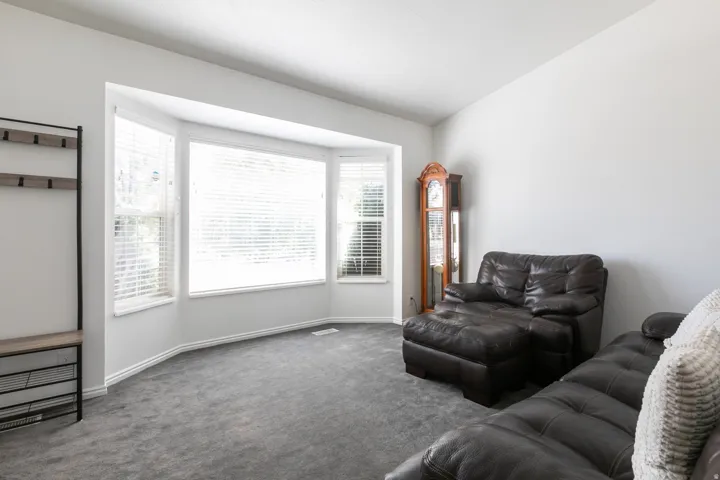 Bay window with multiple panels, white trim, and Venetian blinds